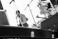 Musical band is playing on open-air at summer festival, view from behind of the stage, black carrying case for guitar