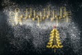Musical Christmas Italian pasta in the form of notes and a Christmas tree, isolated on a black textural background Royalty Free Stock Photo