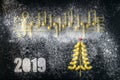 Musical Christmas Italian pasta 2019 in the form of notes and a Christmas tree, isolated on a black textural background Royalty Free Stock Photo