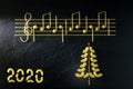 Musical Christmas Italian pasta in the form of notes and a Christmas tree, isolated on a black textural background Royalty Free Stock Photo