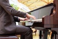 Handsome young men playing piano at the restaurante Royalty Free Stock Photo