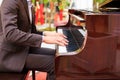 Handsome young men playing piano at the restaurante Royalty Free Stock Photo