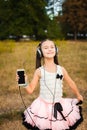 Musical girl dancing with smartphone