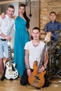 Musical group of three guys and one girl in Recording Studio Royalty Free Stock Photo