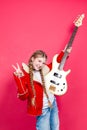 Musical Ideas. Expressive Caucasian Teenage Guitar Player With White Bass Guitar Posing In Fashionable Red Jacket With Lifted