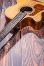 Close up of acoustic guitar. Acoustic guitar against an old wooden background Royalty Free Stock Photo