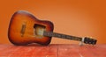 Musical instrument - Broken classic acoustic guitar orange wall Royalty Free Stock Photo