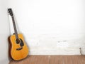 Musical instrument - Classic acoustic guitar white brick background Royalty Free Stock Photo