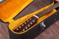 Musical instrument - Fragment neck twelve-string acoustic guitar in hard case Royalty Free Stock Photo