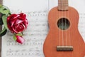 Musical instrument guitar on the background of sheets of sheet music Royalty Free Stock Photo