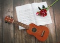 Musical instrument guitar on the background of sheets of sheet music Royalty Free Stock Photo