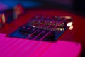 Musical instrument guitar body close-up an macro background, red color light, bokeh and blur focus Royalty Free Stock Photo