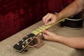 Guitar repair and service - Worker polishing guitar neck frets S Royalty Free Stock Photo