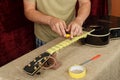 Guitar repair and service - Worker preparation pasting of frets