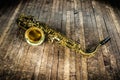 golden saxophone wind instrument on wooden brown stage Royalty Free Stock Photo