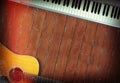 Musical instrument - MIDI keyboard and acoustic guitar wood background Royalty Free Stock Photo
