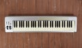 Sloseup MIDI piano 61 key keyboard on a wooden background Royalty Free Stock Photo