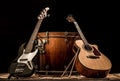 musical instruments, bass drum barrel acoustic guitar and bass guitar on a black background Royalty Free Stock Photo