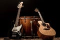 musical instruments, bass drum barrel acoustic guitar and bass guitar on a black background Royalty Free Stock Photo