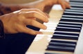 On a musical keyboard instrument man plays a melody with his hands