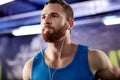 Musical motivation for his workout. a young man listening to music during his workout at the gym. Royalty Free Stock Photo