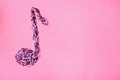 Musical note made of topping on pink background Royalty Free Stock Photo