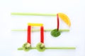 Musical notes made of fruits and vegetables on white background Royalty Free Stock Photo