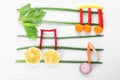 Musical notes made of vegetables and fruits on white Royalty Free Stock Photo