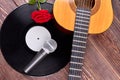Musical objects and flower on wooden background.