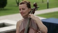 Musical quartet. Girl playing cello in a quartet of violinists. Close up.