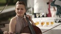 Musical quartet. Girl playing cello in a quartet of violinists. Medium shot.