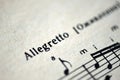 Musical tempo `Allegretto` in a music book Royalty Free Stock Photo