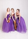 Musical trio in purple dresses