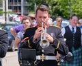 Musician in a band plays a bright brass trumpet during an outdoor parade in Dartmouth, Canada