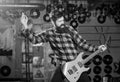 Musician with beard play electric guitar. Man with shouting face play guitar, singing song, play music, Royalty Free Stock Photo