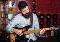 Musician with beard play electric guitar musical instrument.