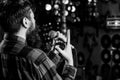 Musician with beard singing song in karaoke, rear view. Rock singer concept. Man in checkered shirt holds microphone Royalty Free Stock Photo