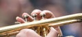 Musician with brass trumpet plays classical music. Close up view with details, blurred background, banner.