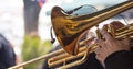 Musician with brass trumpet plays classical music. Close up view with details, blurred background. Royalty Free Stock Photo