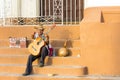 Guitar player calls to passers by in Trinidad, Cuba
