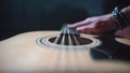 The musician checks the guitar before buying.