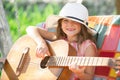 Musician child playing guitar. Kid girl singing and playing guitar outside. Kids music and songs. Smiling child playing Royalty Free Stock Photo