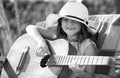 Musician child playing guitar. Kid girl singing and playing guitar outside. Kids music and songs. Smiling child playing Royalty Free Stock Photo