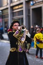 Musician in fun costume celebrating at the carnival Fasching on Rose Monday parade in the city