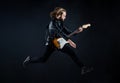 musician guitar player jumping. playing rock music. stylish crazy man. string musical instrument. Royalty Free Stock Photo