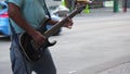 Musician guitarist playing street car limosine passing by