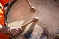 Musician hands with drum sticks playing a bass drum