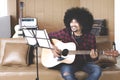 Musician with hands in guitar inside recording studio Royalty Free Stock Photo