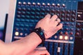 Musician hands tuning sound panel closeup