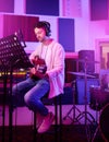 Musician, headphones or guitar in neon studio, recording production or performance on radio mic, label or band concert